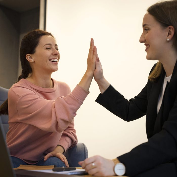 side-view-smiley-women-high-five